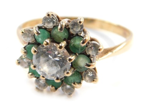 A gold flower head dress ring, set with emerald and CZ stones, formed as layers, hallmarks rubbed, size T, 3.3g all in.