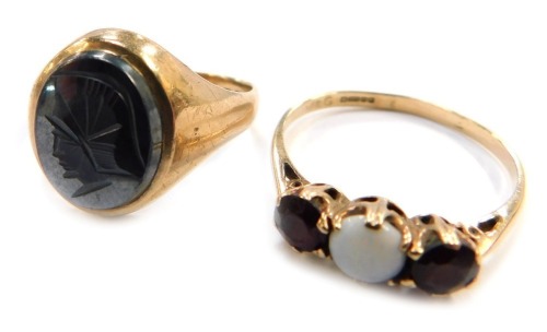 Two 9ct gold rings, being a signet ring with centurion intaglio, size O 1/2, the other opal and garnet, size T, 6.2g all in. (2)