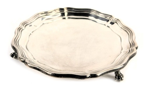 A George VI silver card tray, with piecrust border raised on three ball and claw feet, James Dixon and Sons Ltd, Sheffield 1944, 7.34oz, 15cm diameter.