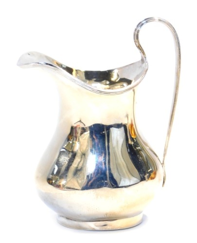 A George V silver cream jug, with a raised line rim, of baluster form, Birmingham 1922, 5.26oz, 12cm high.