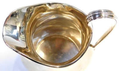 A George V silver cream jug, with a raised line rim, of baluster form, Birmingham 1922, 5.26oz, 12cm high. - 2