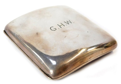 A George V silver cigarette case, of curved form, initial engraved GHW, containing Players cigarettes within, Chester 1914.