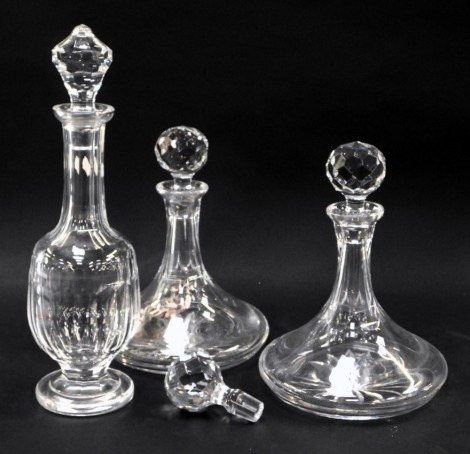 Three cut glass decanters, to include a near pair of ship's decanters, 16cm and 17cm high, together with a Waterford Curraghmore cut glass decanter and stopper. (4)