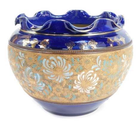 A Royal Doulton Slaters Patent jardiniere, of cylindrical tapering form with waved rim, china decorated with a band of flowers against a dark blue ground with gilt highlights, impressed marks, 21cm high.