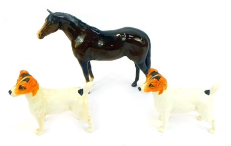 A Beswick pottery model of a brown horse, printed marks, 22cm high (AF), together with two Beswick Jack Russell Terriers, 13cm high.