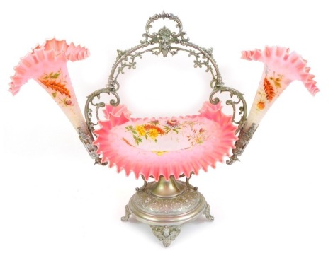 A Victorian cast metal and frosted glass centrepiece, the frame decorated with figural busts, scrolls, etc., with a central pink frosted glass dish decorated with flowers and butterflies flanked by two matching trumpet vases, the base cast with cherub mas