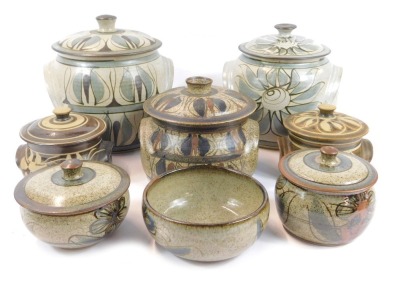 A group of Terry Godby studio pottery, to include a pair of jar and covers, 22cm high, and a bowl, 13cm diameter, etc., each piece decorated with floral motifs. (7)