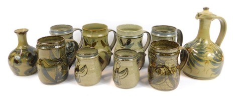 A group of Terry Godby studio pottery, to include mugs, flagon and stopper, 24cm high, vase, etc., each piece decorated with floral motifs, two mugs painted with an angel, etc. (10)