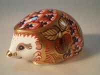 A Royal Crown Derby paperweight in the form of a hedgehog.