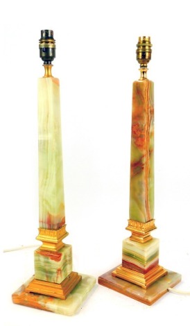 A pair of 20thC onyx and brass table lamps, of square tapering form, on square bases, 54cm high. WARNING! This lot contains untested or unsafe electrical items. It is supplied for scrap or re-conditioning only. TRADE ONLY