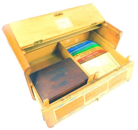 A 20thC oak Butterfly Brand salesman's box, with a hinged compartment to the top, the front with a hinged fall enclosing a label for Local Representative Mr E Boyer and a paper Estimator's Guide label, containing a min century chiropody instrument set, an
