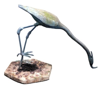 A garden sculpture modelled as a heron, in resin, on a composition base, 74cm high.