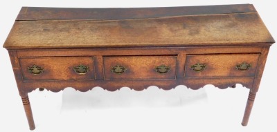 A late 18thC oak dresser, with three drawers, above a shaped apron, raised on ring turned legs, 76cm high, 161cm wide, 48.5cm deep. - 2