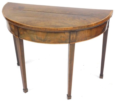 A George III mahogany demi lune card table, with rosewood cross banding, opening to reveal a baize interior, raised on tapering square legs, on spade feet, 73cm high, 92cm wide, 45.5cm deep. (AF) - 3