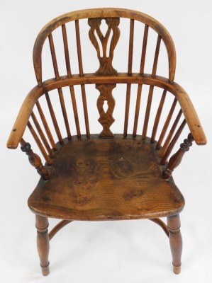 An early 19thC oak and elm Windsor chair, with a carved splat, solid saddle seat, raised on turned legs united by a crinoline stretcher, 54cm wide. (AF) - 2