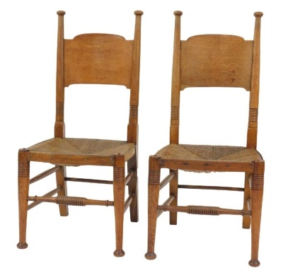 A pair of early 19thC oak and rush seated country chairs, 43cm wide.