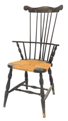 A late Victorian beech comb back chair, with a rush seat, raised on turned legs united by a double edge stretcher, 54cm wide.