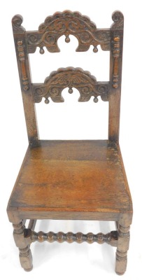 A late 17thC oak back stool, probably Yorkshire, with a carved back, solid seat, raised on turned legs united by plain and bobbin turned stretchers, 45cm wide. - 2