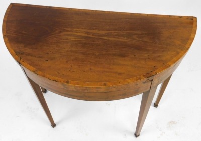 A George III mahogany demi lune card table, with rosewood cross banding, with a baize interior, raised on tapering square legs and spade feet, 74cm high, 99cm wide, 49cm deep. - 3