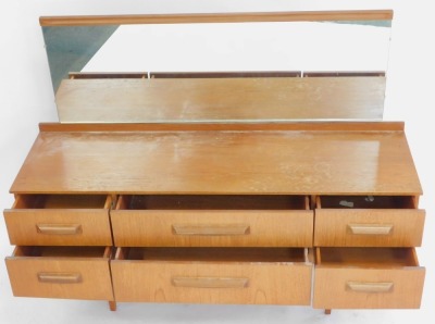 A mid century teak dressing chest, with a capped rectangular mirror plate, above two long drawers flanked by four short drawers, raised on tapering square legs, 115cm high, 149cm wide, 45.5cm deep. - 2