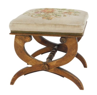 A Victorian oak X framed stool, with a floral wool work seat, 46cm wide.