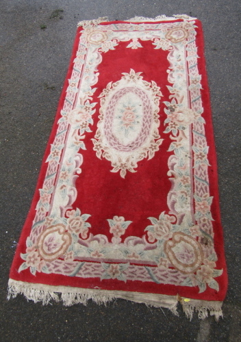 A Chinese red ground rug.