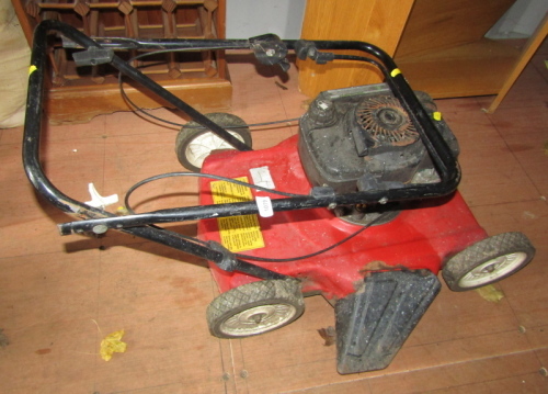 A Prisma 37 petrol lawn mower.