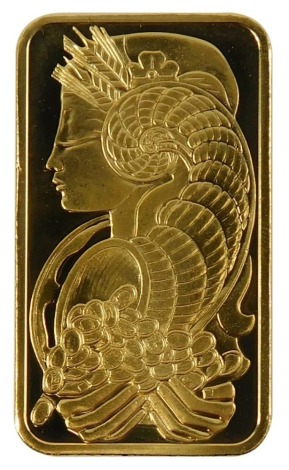 A Saudi Arabian fine gold ingot, the front displayed with lady with cornucopia of coins, the reverse marked Pmap Suisse 50g Fein Gold 999.9 chiasso, in plastic sealed case.