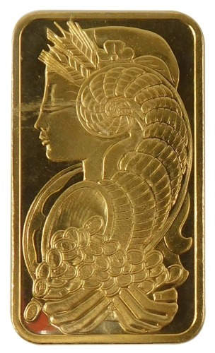 A Saudi Arabian fine gold ingot, the front displayed with lady with cornucopia of coins, the reverse marked Pmap Suisse 50g Fein Gold 999.9 chiasso, in plastic sealed case.