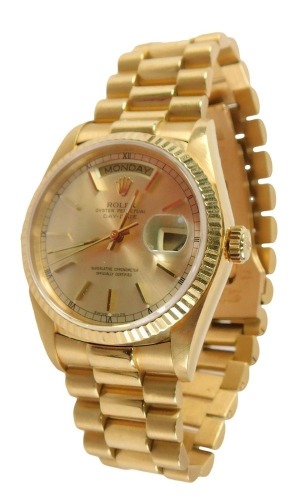 A Rolex Oyster perpetual Day-Date 18ct gold gentleman's wristwatch, the gold dial with Roman numeric border, in date and day apertures, on bracelet, stamped 18k to lugs, the back case stamped Switzerland 18k 750, 18000, opening to reveal a Swiss 27 jewel