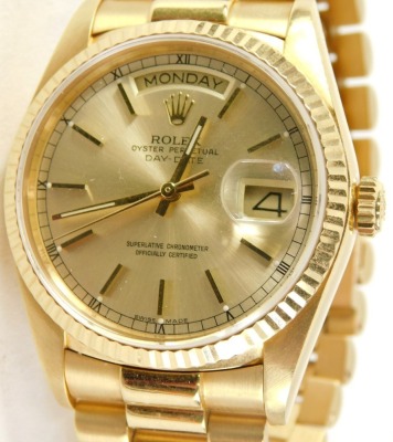 A Rolex Oyster perpetual Day-Date 18ct gold gentleman's wristwatch, the gold dial with Roman numeric border, in date and day apertures, on bracelet, stamped 18k to lugs, the back case stamped Switzerland 18k 750, 18000, opening to reveal a Swiss 27 jewel - 2