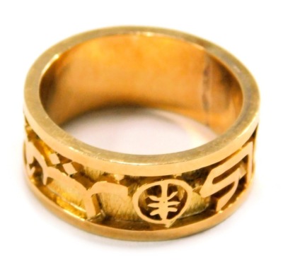 A wedding band, designed with Arabic writing, symbols and numbers, the yellow metal band stamped 18kt, ring size T, 10.5g all in.