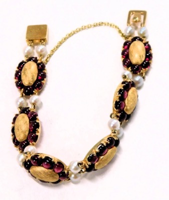 A Lucien Piccard Edwardian style bracelet, formed as oval sections set with cabochon rubies and two cultured pearl breaks, in yellow metal backing stamped 14k, with safety chain, 18cm long, 30.8g all in. - 2