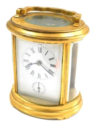 A 19thC carriage clock, with gilded border over a white enamel Roman numeric face plate with seconds dial, with a thirty hour keywind movement, with oval bevelled plates, 13cm high.