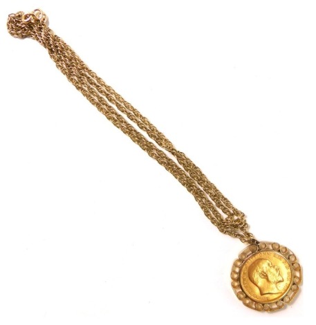 An Edward VII full gold sovereign pendant, dated 1909 in a yellow metal mount stamped 9ct, on fancy link neck chain stamped 9ct with additional safety chain, 54cm long, 17.2g all in.