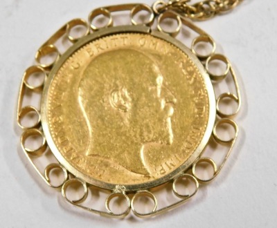 An Edward VII full gold sovereign pendant, dated 1909 in a yellow metal mount stamped 9ct, on fancy link neck chain stamped 9ct with additional safety chain, 54cm long, 17.2g all in. - 2