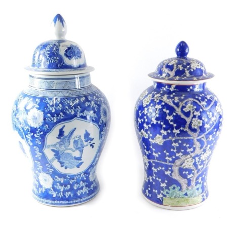 A modern Chinese porcelain vase and cover, decorated in blue with flowering prunus, and a similar blue and white jar and cover.