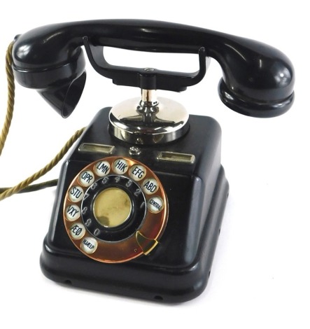 A Scandinavian Kjobenhavns Telefon Bakelite ebonised metal and copper telephone, with register to the top.