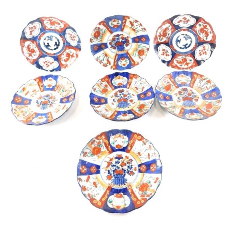 Seven various Meidi period Japanese Imari porcelain dishes, each decorated in typical style with fish, etc.