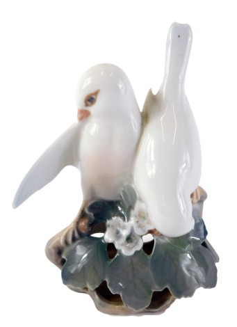 A Royal Copenhagen porcelain figure group of lovebirds, numbered 402 to underside, with a pierced base, 14cm high.