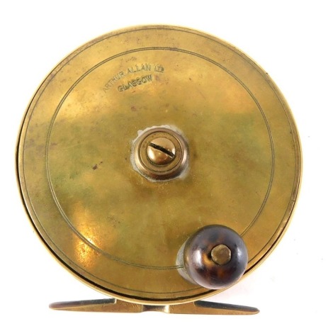 An Arthur Allan Limited of Glasgow brass fly fishing reel, with turned hardwood handle, 10cm diameter.