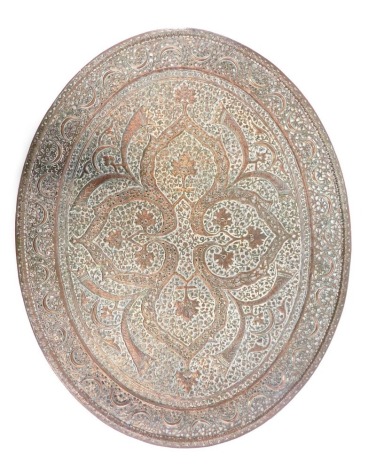 An elaborate pierced and engraved Indian oval copper tray or plaque, decorated with scrolls, stylised horns, etc., 61cm x 48cm.