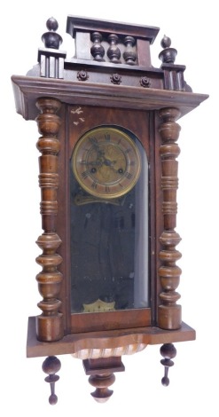 A late 19thC Vienna wall clock in walnut case, the dial with pressed metal centre and paper chapter ring, 83cm high. (AF)