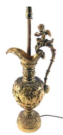 A late 19th/early 20thC Continental gilt metal table lamp, modelled in the form of a ewer decorated with putti, grapes, vines, etc., 64cm high.