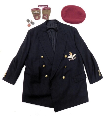 A Parachute Regiment black blazer, with insignia to pocket, a maroon coloured beret, and various parachute badges.