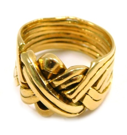 A puzzle ring, of eight layered design, yellow metal unmarked believed to be 18ct gold, ring size U, 14.7g all in.