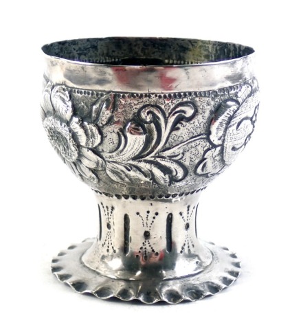 A German silver cup or chalice, with embossed decorated of flowers and leaves, on a tapering base, the base inset with white metal medallion, with Hebrew writing, 3.75oz, 8cm high.