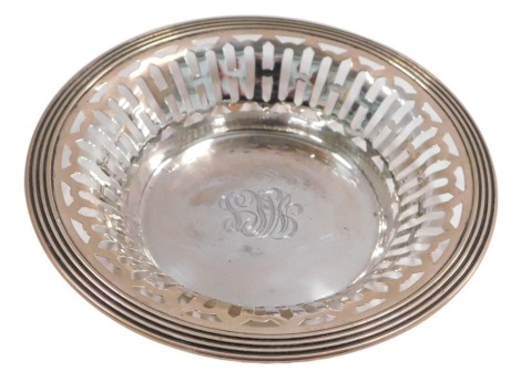 A late 19th/early 20thC silver sweet meat dish, of circular form with pierced decoration, monogram engraved to centre, stamped to underside sterling, 2.43oz, 15cm diameter.