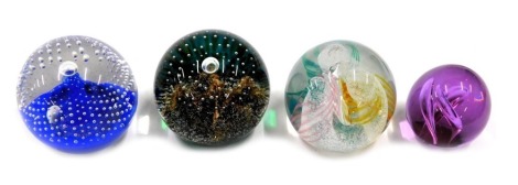 Four Caithness and other paperweights, comprising three large to include Day Dreams, Moon Mountains, Star Light, and a small purple example unmarked. (4)