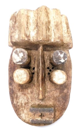 A Grebo (Kru) four eyed 'Diviners' mask with faded kaolin pigments, Liberia, approximately 60 years old, 45cm high.